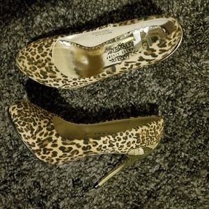 Leopard pumps with gold heel.